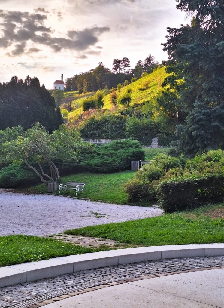 Picturesque Hilltop Church int he Distance from a Park in Maribor